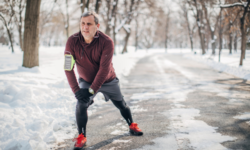 Older Man Stretching Outside in the Winter