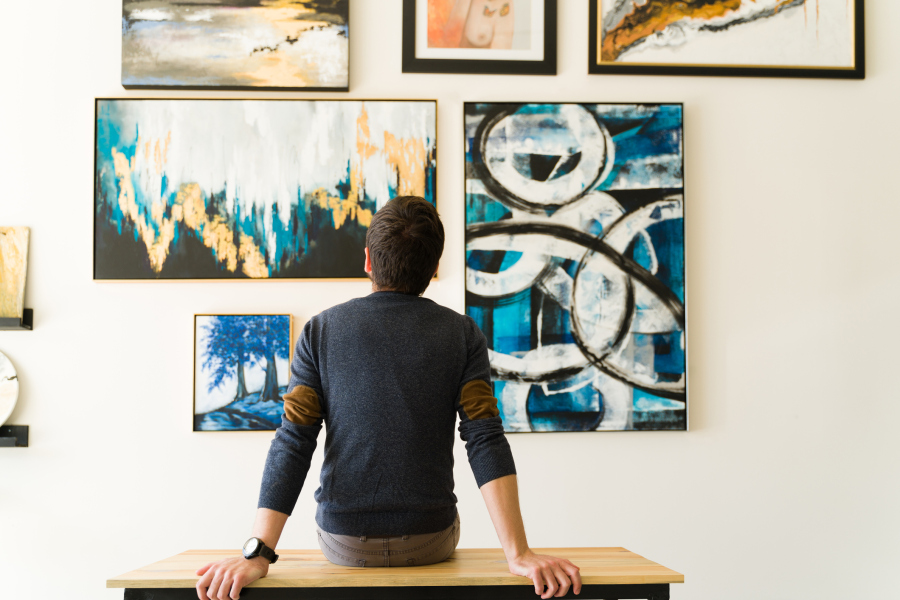 Man in His Thirties Looking at Art on Wall