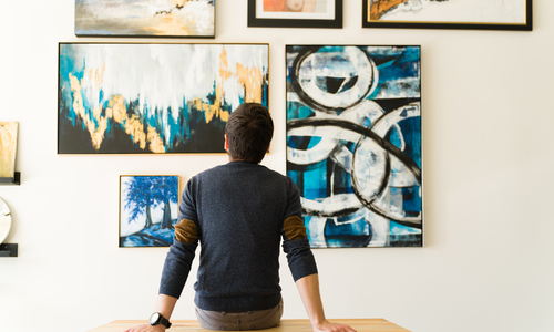 Man in His Thirties Looking at Art on Wall