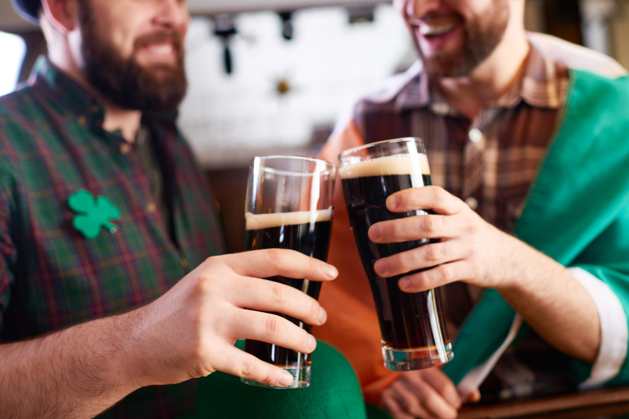 St. Patrick's Day friends cheers over dark beer